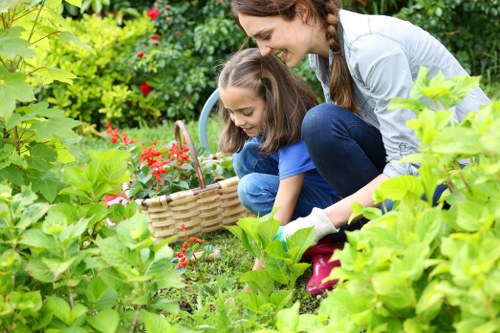 Photo of a gardener inspecting a garden bed